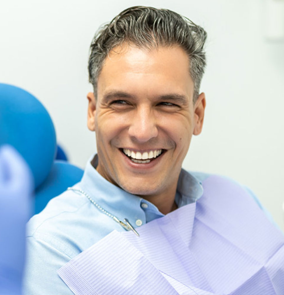 Guy smiling at doctor at Restore Denture & Implant Center