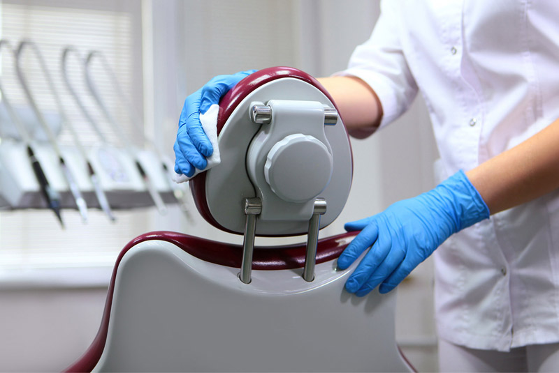 Doctor cleaning dental chair