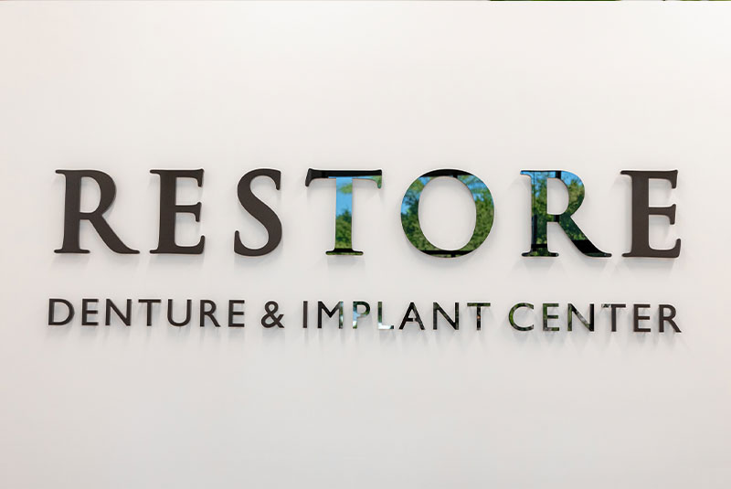 Restore Denture & Implant Center logo