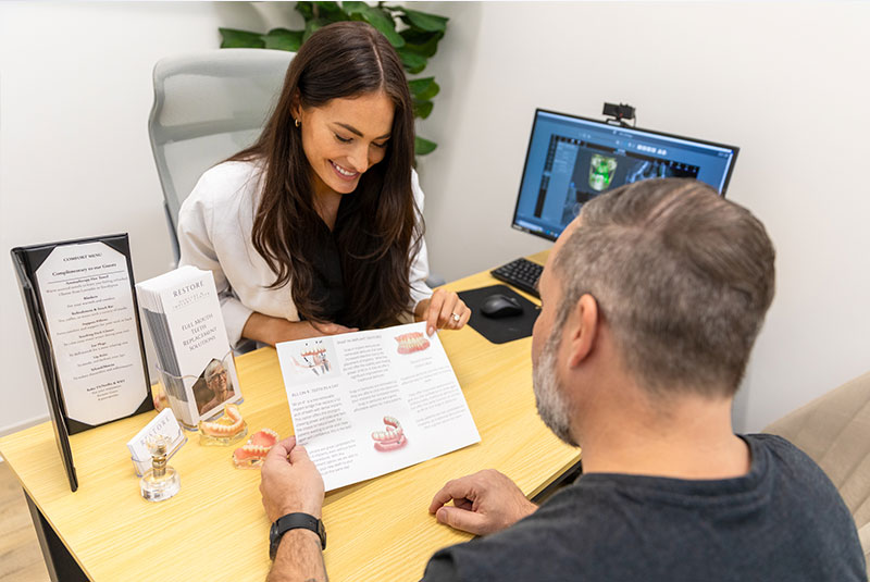 doctor going over dental procedure information with patient within the dental practice