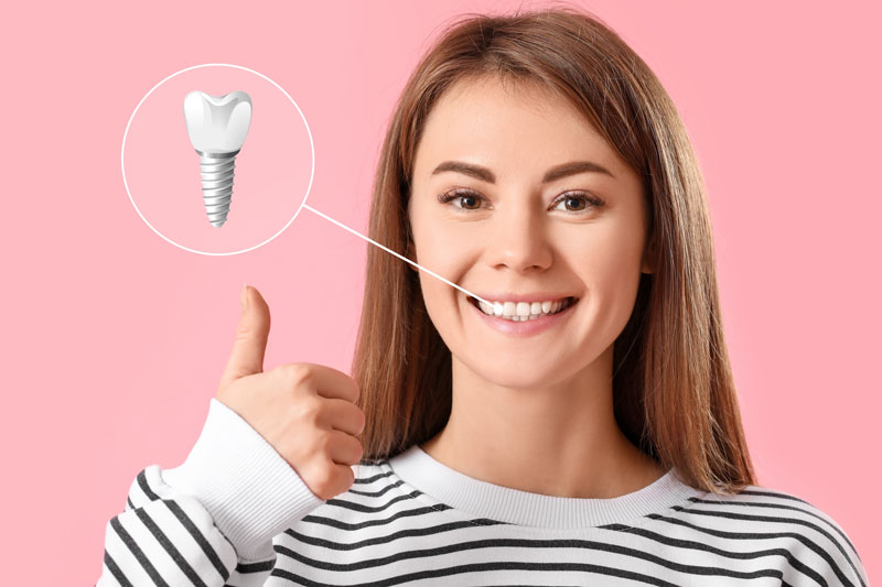 a woman smiling with dental implants highlighting her smile makeover